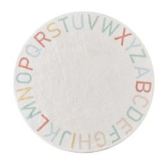 a white coaster with multicolored letters on it