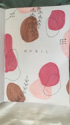 an open notebook with drawings on it and the words, april written in black ink