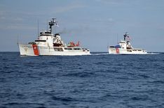 two boats in the water near each other