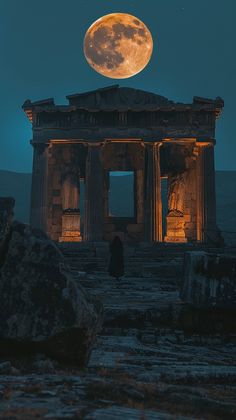 the full moon is setting over an ancient building