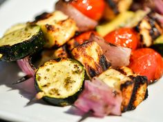 grilled vegetables are arranged on a white plate