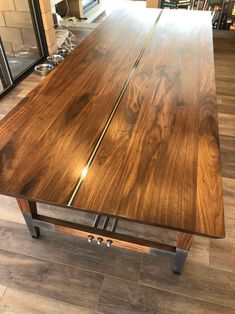 a wooden table sitting on top of a hard wood floor