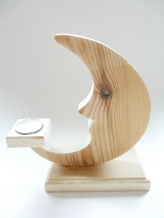 a wooden sculpture with a ring on it