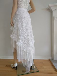 "Unique, bohemian high- low style wrap skirt. Made from white 3D lace and tulle with multi lace/tulle raffles. 40\"- 47\" across plus long lace ties and to the wrap and overlap 25\" to 35\" waist and it can easily fit up to 45\"- 46\" hips.  The V hemline length is 30\" at the front and 49\" at the back. Or this skirt can be make with your waist, hips and length measurements.  Waist Sizing: S-4-6, Waist: 25.5\"-26.5\", Hip: 36-37\"  M-8-10, Waist:  28\"-29\", Hip: 38-39\" L-12-14, Waist: 30-32\" Fitted Lace Maxi Skirt With Ruffles, Spring Wedding Skirt With Ruffles, Long Ruffled Skirt For Wedding, Bohemian Ruffled Maxi Skirt For Party, Bohemian Tiered Tulle Skirt, Summer Wedding Skirt With Ruffles, Spring Wedding Maxi Skirt With Ruffles, Wedding Long Skirt With Ruffles, Spring Wedding Lace Maxi Skirt