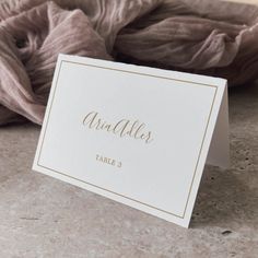 a table name card sitting on top of a counter next to a pile of blankets