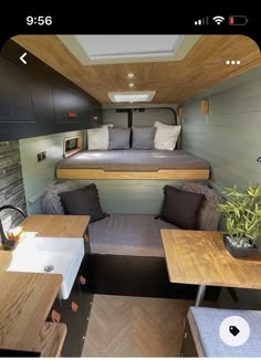 the interior of a tiny house with two beds and couches