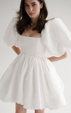 a woman wearing a white dress and wings