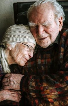 an older man and woman embracing each other