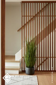 A walnut & brass slatted stairway wall. Slatted Accent Wall, Mid Century Modern Foyer, Modern Foyer, Walnut Cabinet, Entryway Design, Foyer Design, Entry Way Design