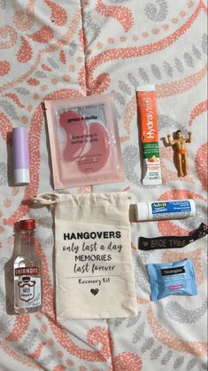 an assortment of personal care items laid out on a bed with the words hangoverers