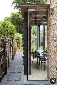 an outdoor dining area with brick walls and patio furniture