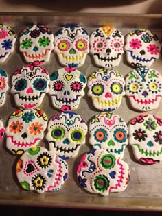 decorated sugar cookies are arranged in the shape of skulls