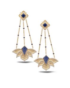 The Blue Lotus Trinetra Drop Earrings Set In 20K Yellow Gold With Blue Sapphire, Crystal & Diamonds. 3.13ct Crystal 2.31ct Blue Sapphire 1.35ct Diamond 2.9 X 1.2in Introducing COOMI's newest masterpiece, The Trinetra Collection. Inspired by the profound symbolism of the Sanskrit word Trinetra, which translates to "three eyes, this collection embarks on a spiritual and artistic journey. In Hinduism, Lord Shiva is referred to as Trinetra because he is often portrayed with a third eye, a powerful s Exquisite Blue Earrings For Evening, Luxury Blue Chandelier Earrings For Formal Occasions, Luxury Blue Diamond Earrings As Gift, Luxury Blue Earrings For Evening Wear, Luxury Blue Earrings For Evening, Blue Earrings With Intricate Design For Gift, Traditional Blue Earrings With Intricate Design, Luxury Blue Drop Earrings, Blue Dangle Earrings With Intricate Design