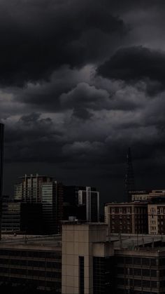 dark clouds loom over the city skyline