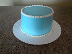 a blue and white cake sitting on top of a counter