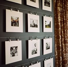 a wall with many pictures hanging on it