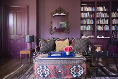 a living room with purple walls and furniture