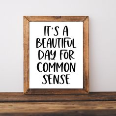 it's a beautiful day for common sense printable poster in wooden frame on shelf