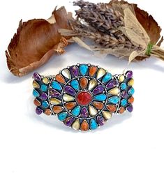 "Brand new amazing high quality handcrafted sterling silver Southwestern style cuff bracelet with natural genuine multicolor stones consisting of American Sleeping Beauty Turquoise, Purple Turquoise, Mother of Pearl, and Spiny Oyster Shell stones. The Turquoise stones are mined from Kingman, Arizona. The bracelet's inner circumference measures 7\" and is adjustable to fit many wrist size. It can be squeezed in to fit a 6.25\" wrist or it can be extended out to fit up to a 8.5\" wrist. The width Silver Southwestern Cuff Bracelet With Natural Stones, Adjustable Multicolor Southwestern Cuff Bracelet, Southwestern Multicolor Adjustable Cuff Bracelet, Adjustable Southwestern Multicolor Jewelry, Artisan Multicolor Multi-stone Bracelets, Multicolor Natural Stones Cuff Bangle, Adjustable Multicolor Sterling Silver Bracelet With Natural Stones, Multicolor Artisan Sterling Silver Bracelets, Artisan Multicolor Sterling Silver Bracelets