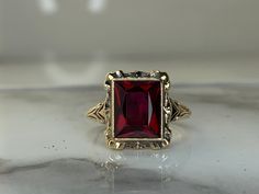 10kt yellow gold ring set with a 9.5x7.5mm synthetic Ruby! Weighs 2.0dwt, is 13.7mm at its widest point and is currently a size 6.25 but can be resized! Ruby Vintage Ring, Vintage Ruby Engagement Ring, Lannister Aesthetic, Red Sapphire Ring, Beautiful Fingers, Jewelry Smithing, Spooky Accessories, Ruby Engagement Ring Gold, Ruby Jewelry Ring