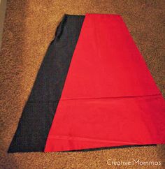 a red and black skirt laying on the floor