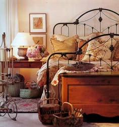 an old fashioned bed in a bedroom with baskets on the floor and a bicycle parked next to it