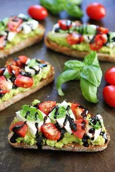 several slices of bread topped with avocado and tomatoes