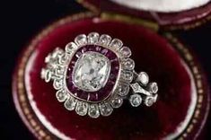 an antique diamond ring sits in a velvet box