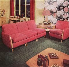 a living room filled with red couches and chairs