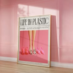 a pink room with a large poster on the wall and two pairs of shoes in front of it