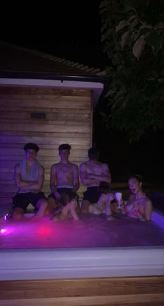 a group of people sitting on top of a hot tub