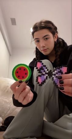 a woman sitting on the floor holding a pinwheel with a ladybug design on it