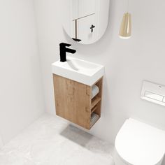 a bathroom with a sink, mirror and toilet in it's corner area next to a wall mounted faucet