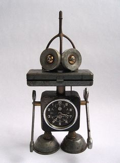 an old fashioned clock with two bells on it's face and legs, sitting in front of a white background