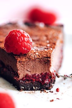 a piece of chocolate cake with raspberries on top