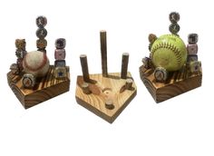 three wooden objects with baseballs and other items on them