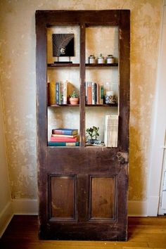 an old wooden book shelf with books on it