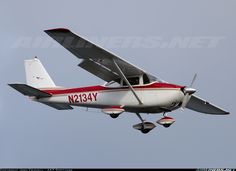 an airplane flying in the sky with propellers on it's wings and landing gear down