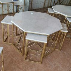 marble tables and stools are arranged on the floor