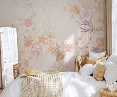 a bedroom with floral wallpaper and white bedding