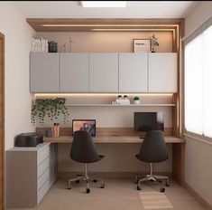 an office with two desks and chairs in front of a wall mounted computer monitor