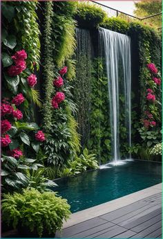 a waterfall in the middle of a pool surrounded by lush green plants and pink flowers