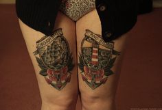 two women with tattoos on their butts are standing in front of the camera and one has her legs crossed