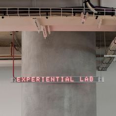 a sign hanging from the ceiling that says experiental lab on it's side