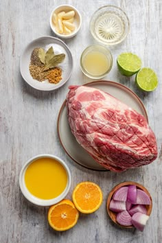 raw meat on a plate surrounded by other ingredients and condiments to make it