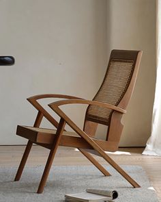 a wooden chair sitting on top of a hard wood floor next to a pair of scissors