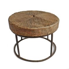 a round wooden table with metal legs and a woven top on an isolated white background