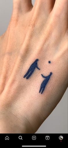 a person's hand with a small tattoo on it, and an image of two people holding hands