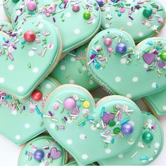 many heart shaped cookies with sprinkles and confetti on them are shown