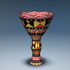 a colorful vase sitting on top of a table